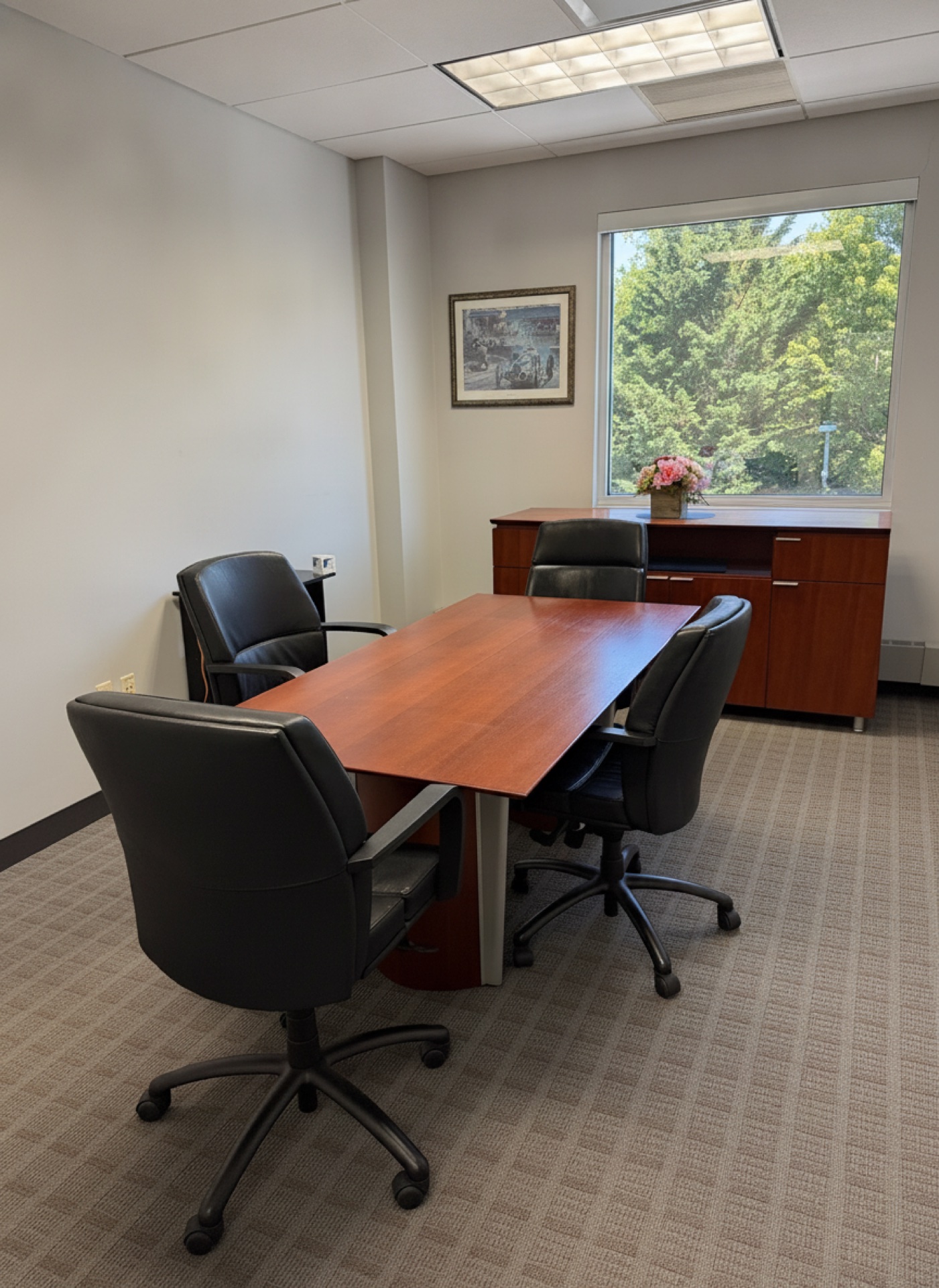 A private meeting boardroom with a wood table