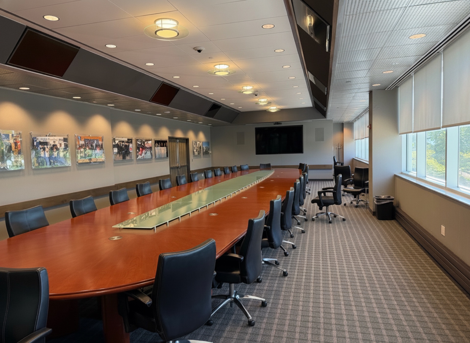 The Executive Boardroom with leather chairs and a wall display